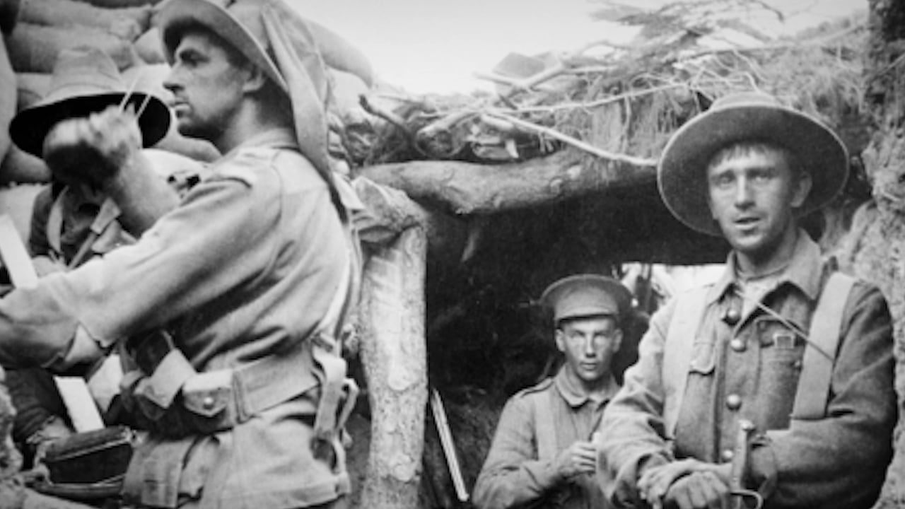 Four World War I soldiers in a timbered trench dugout