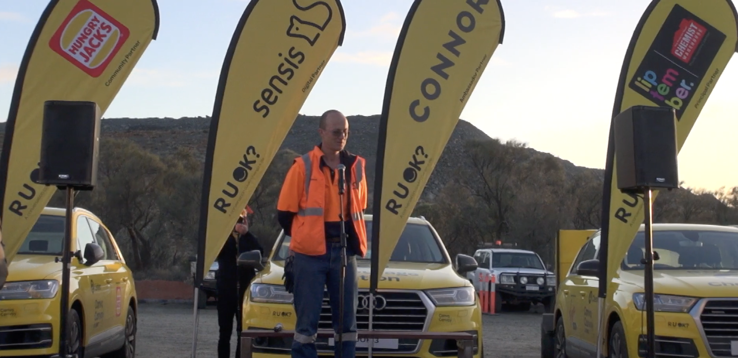 R U OK? Convo Convoy event speaker with branded yellow vehicles and banners